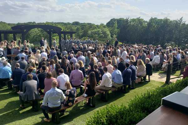 Outdoor wedding ceremony with professional DJ sound system and seated guests